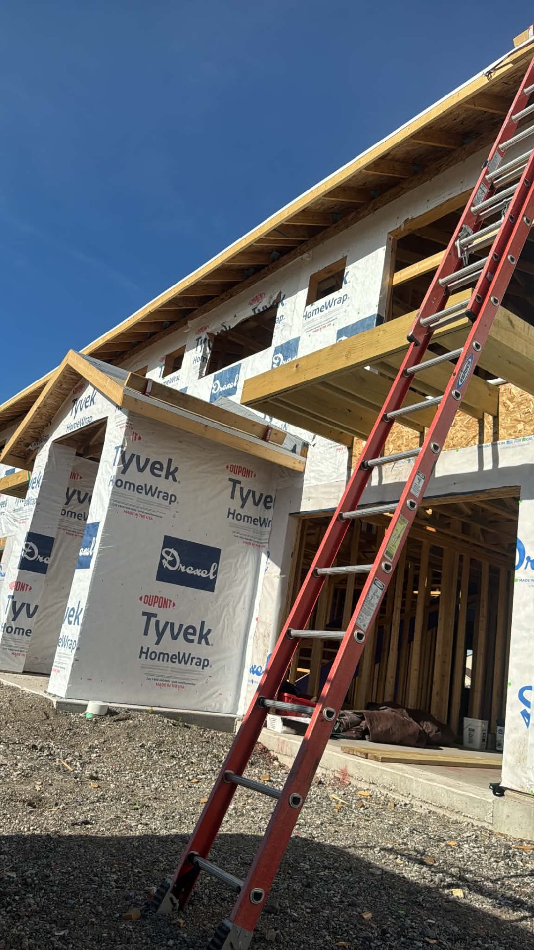New home framing covered in house wrap ready for siding installation